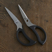 A demonstration of the Kai kitchen scissors' hygienic design, showing the two blades separated for easy and thorough cleaning.
