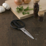 A lifestyle image of the Kai Seki Magoroku kitchen scissors in a kitchen setting, ready for use with fresh ingredients.
