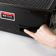 Adjusting the airflow by opening the ventilation window on the side of the Mikawa konro grill.

