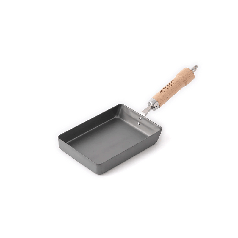 A product image of the River Light Kiwame 13x18cm Tamagoyaki Pan, showcasing its rectangular shape and branded natural wood handle.

