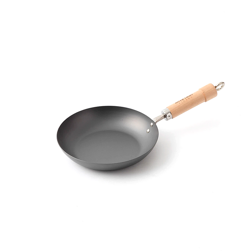 A product image of the River Light Kiwame 24cm Carbon Steel Frypan, showing its classic shape and branded natural wood handle.