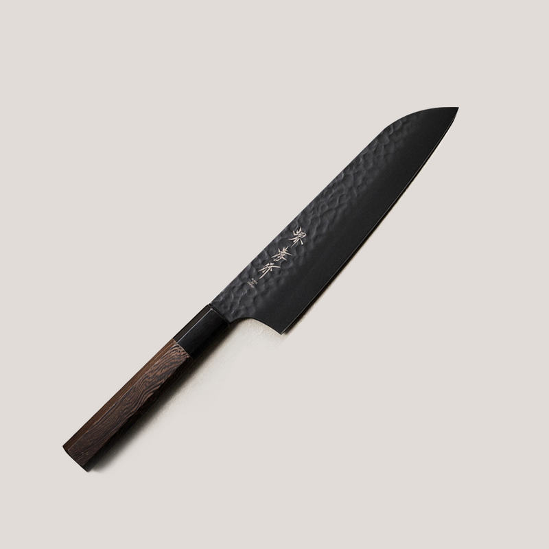 The Sakai Takayuki KUROKAGE Santoku knife (170mm), featuring a black hammered VG10 blade and an octagonal Wenge wood handle with a buffalo horn ferrule.
