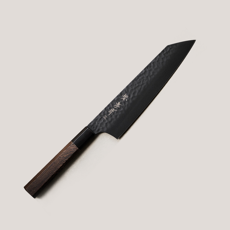 The Sakai Takayuki KUROKAGE Kengata Gyuto knife (190mm), featuring a black hammered VG10 blade with a distinctive sword-like tip and an octagonal Wenge wood handle.
