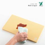 Yoshikawa Anti-bacterial PE Cutting Board being cleaned with a cloth, showing its liquid-resistant surface.